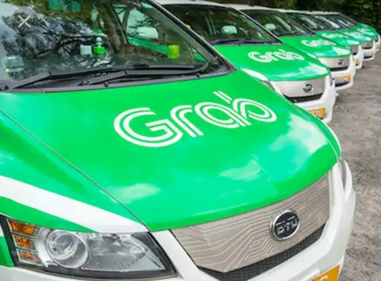 Cần giải quyết dứt điểm “cuộc chiến” giữa Grab và taxi truyền thống