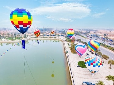 Hot air balloons over a body of water Description automatically generated