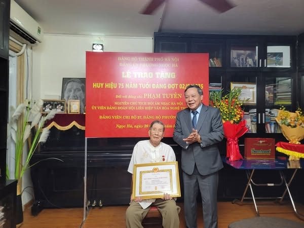 Phó Bí thư Thường trực Thành ủy Hà Nội Nguyễn Văn Phong trao tặng Huy hiệu 75 năm tuổi Đảng cho nhạc sĩ Phạm Tuyên